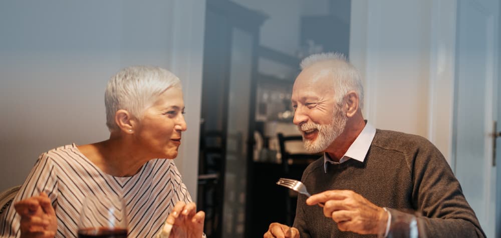 Elderly retired white couple independent living kitchen smiling CU
