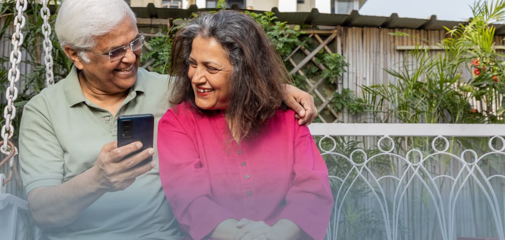 retired elder middle eastern couple on bench at living facility