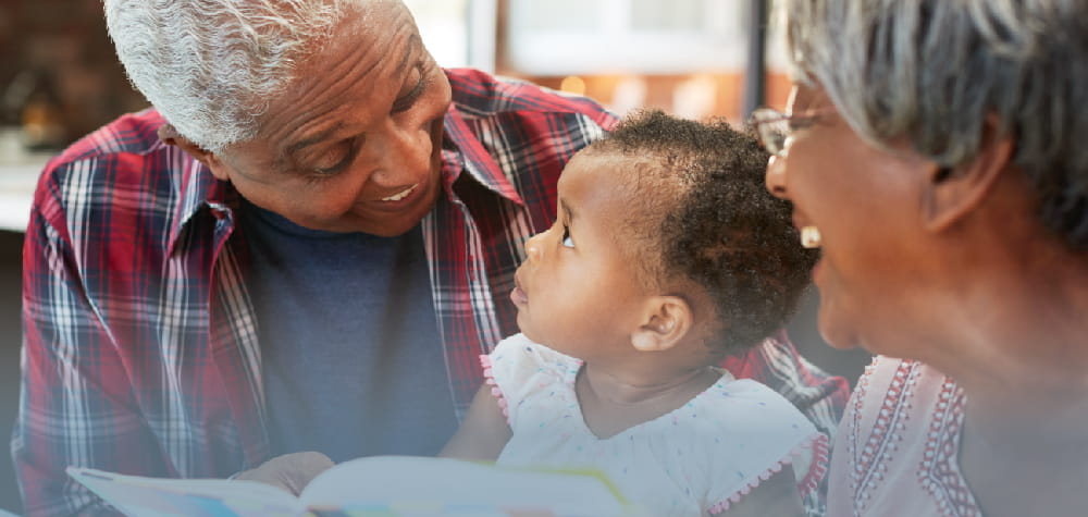 elderly retired black grandparents with grandchild at-home care CU